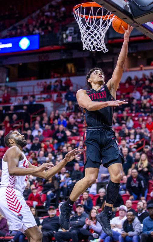UNLV Rebels guard Marvin Coleman (31, right) lays the ball in past New Mexico Lobos guard JaQua ...