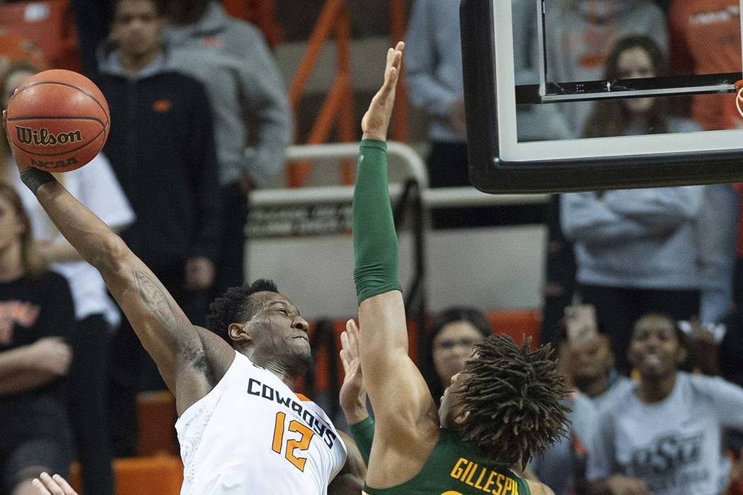 Baylor forward Freddie Gillespie (33) blocks the dunk from Oklahoma State forward Cameron McGri ...