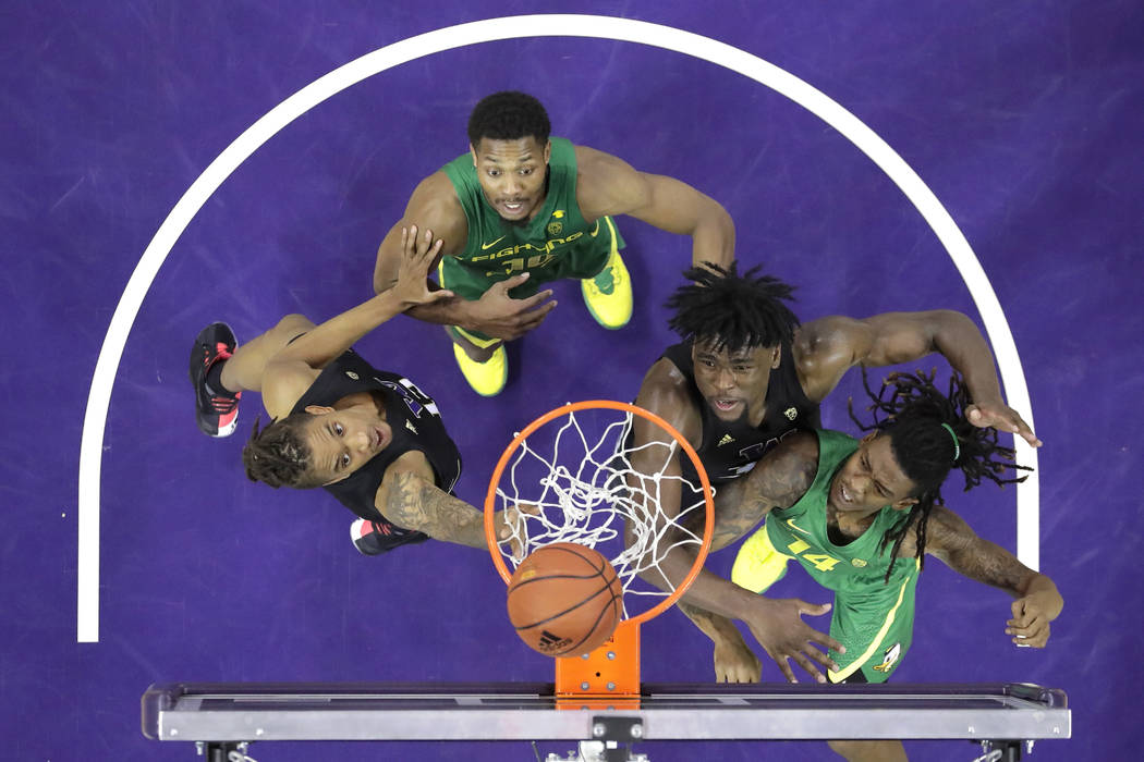 From left, Washington forward Hameir Wright, Oregon forward Shakur Juiston, Washington forward ...