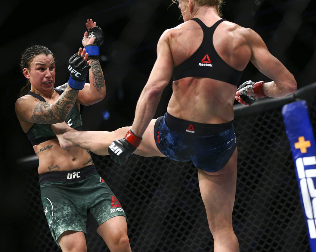 Raquel Pennington, left, fights Holly Holm during their bantamweight bout a...