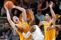 Tennessee forward John Fulkerson (10) loses his headband as he grabs a rebound in front of Vand ...