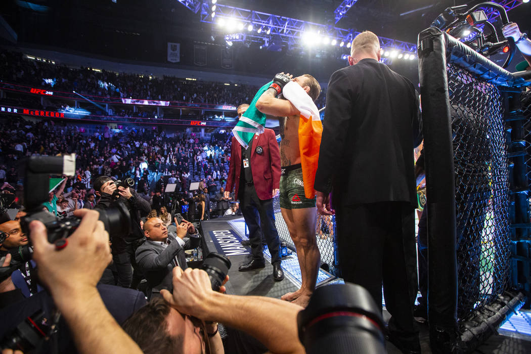 Conor McGregor motions to the crowd after defeating Donald "Cowboy" Cerrone via techn ...