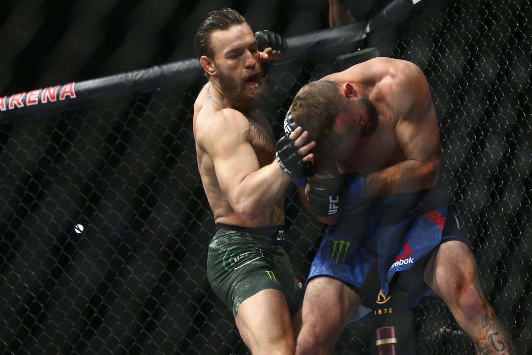 Conor McGregor, left, fights Donald "Cowboy" Cerrone during their welterweight bout a ...