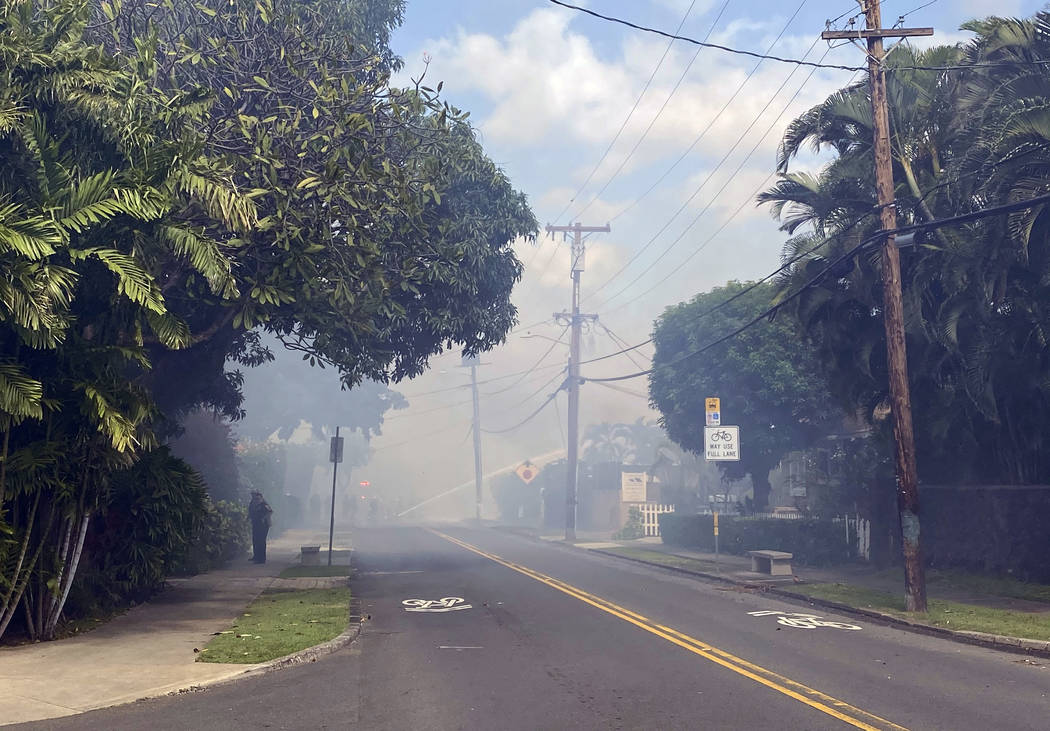 Smoke billows through the streets after a shooting in Honolulu, Sunday, Jan. 19, 2020. The Hono ...