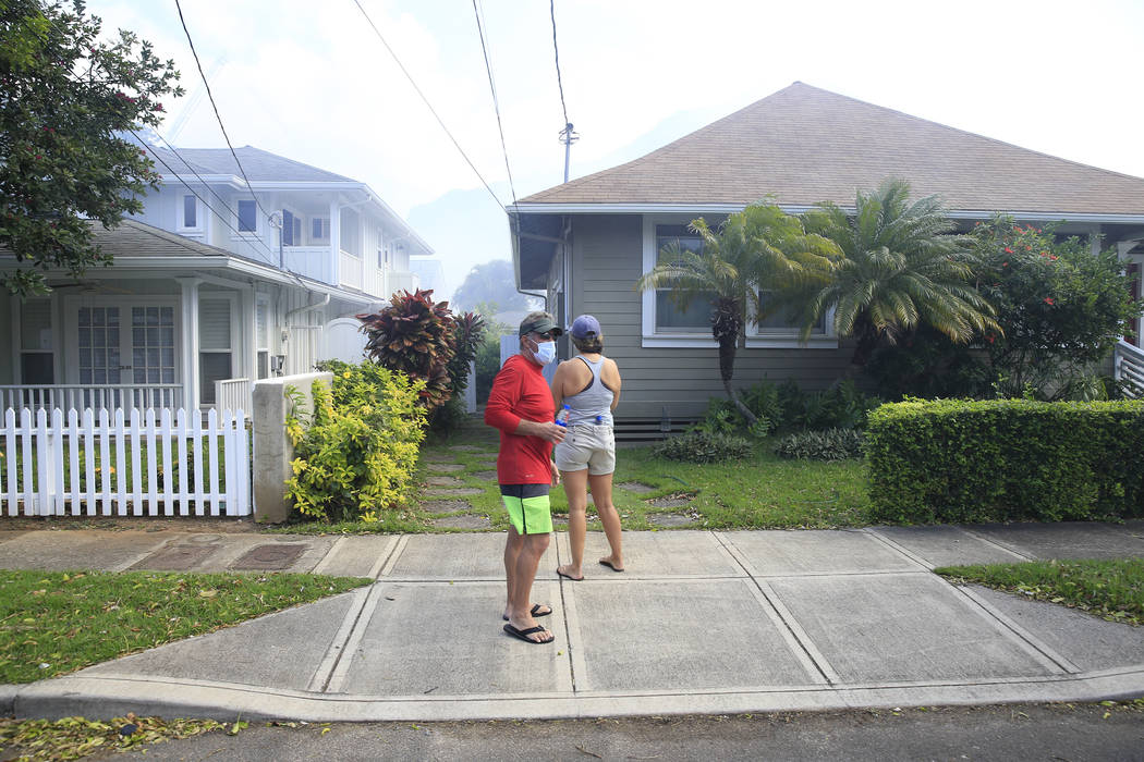 Residents of the Diamond Head neighborhood watch homes burn, Sunday, Jan. 19, 2020, in Honolulu ...