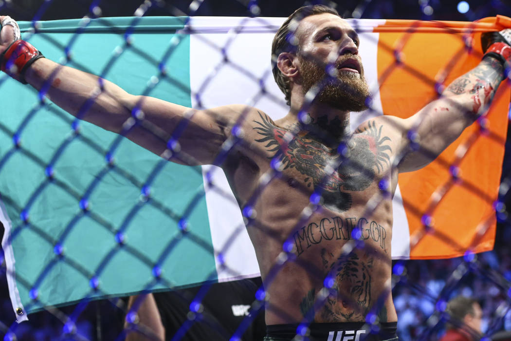 Conor McGregor celebrates after defeating Donald "Cowboy" Cerrone via technical knock ...