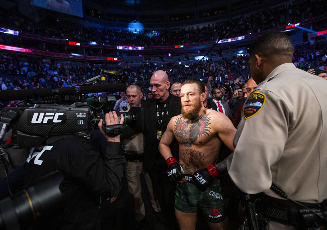 Conor McGregor leaves the octagon after defeating Donald "Cowboy" Cerrone via technic ...