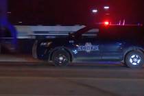 In this image made from video, a police vehicle passes with sirens near the scene of a shooting ...