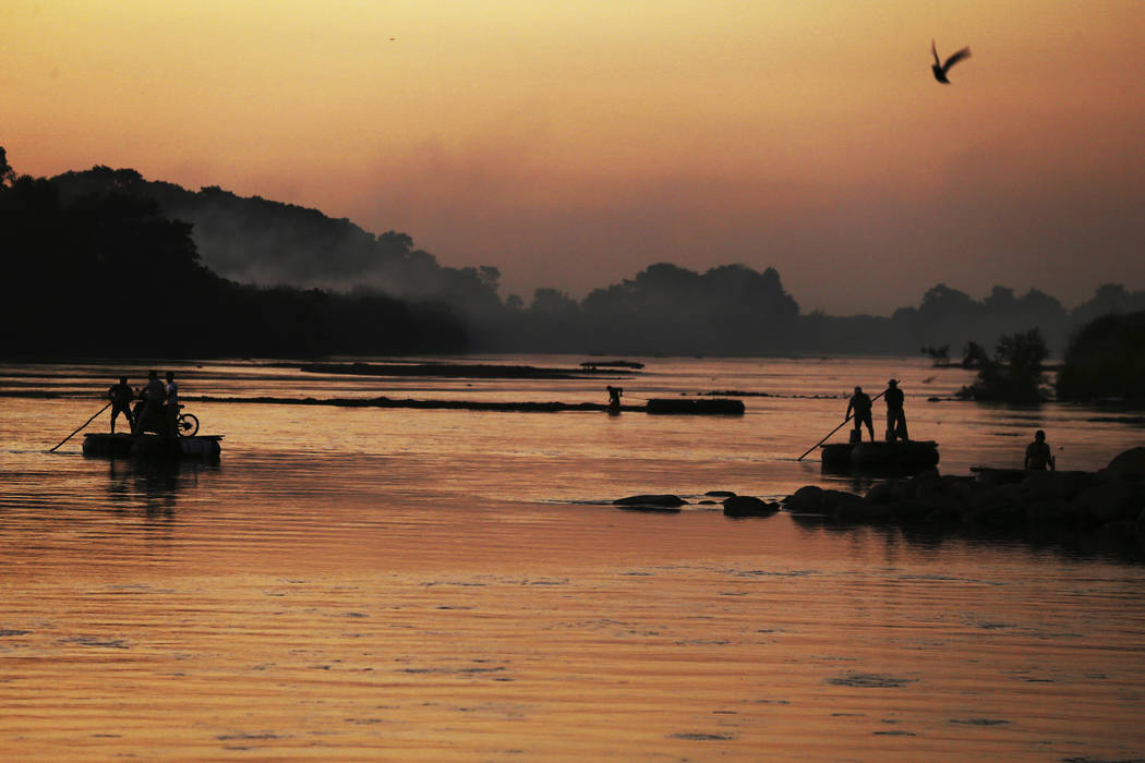 Locals cross the Suchiate River from Mexico to Guatemala near Ciudad Hidalgo, Mexico, Monday, J ...