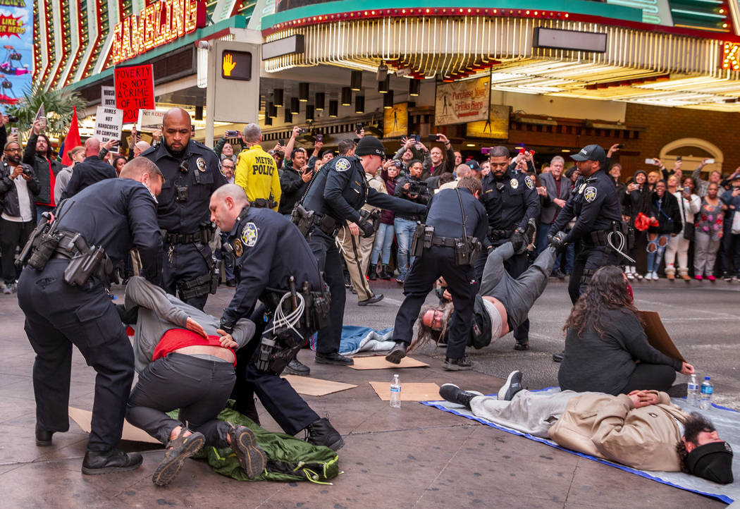 Las Vegas Metropolitan Police officers arrest local activists blocking Casino Center Blvd. thro ...