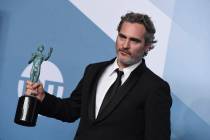 Joaquin Phoenix poses in the press room with the award for outstanding performance by a male ac ...