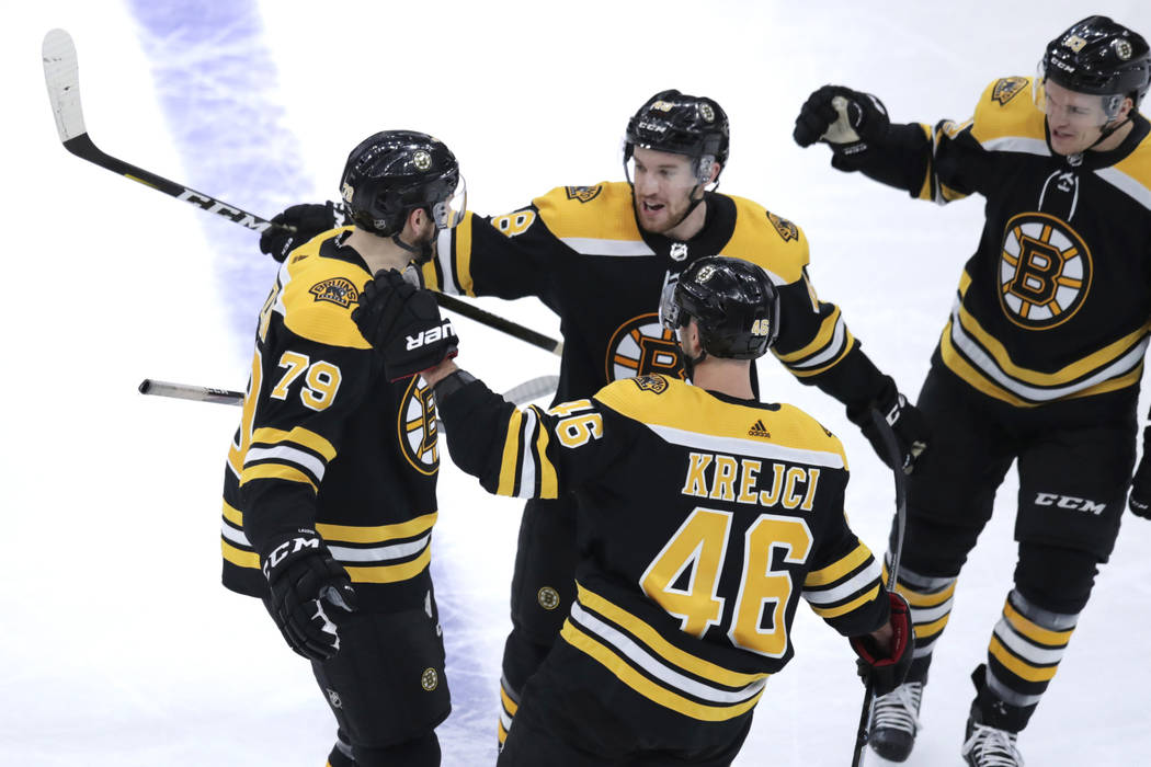 Boston Bruins defenseman Jeremy Lauzon (79) is congratulated by teammates after his goal during ...