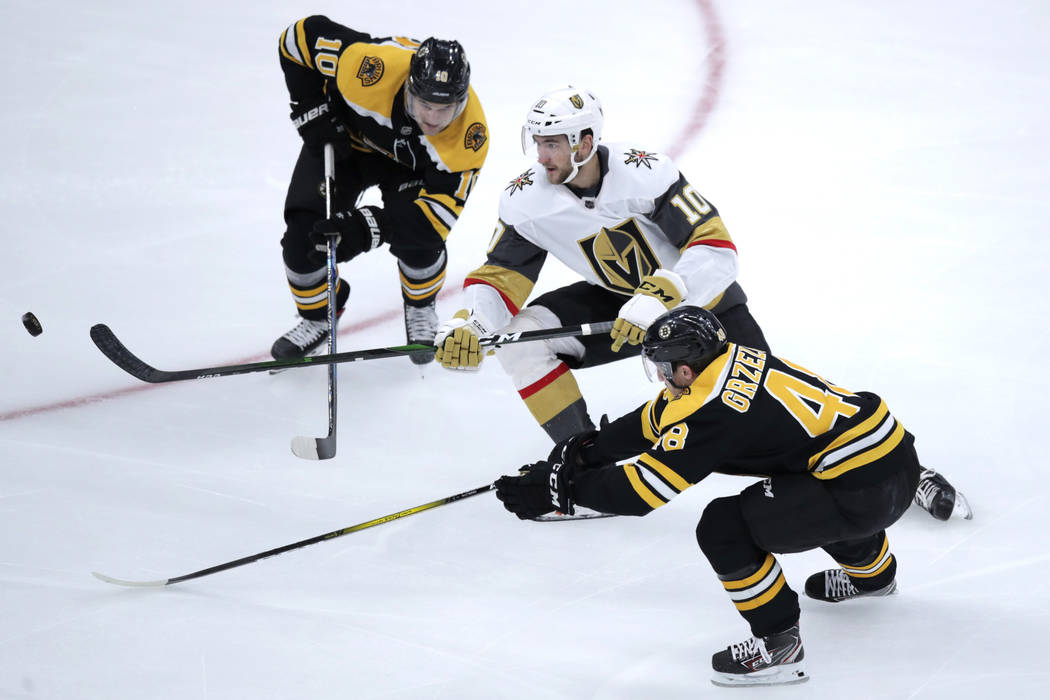 Vegas Golden Knights forward Nicholas Roy (10) threads between Boston Bruins left wing Anders B ...