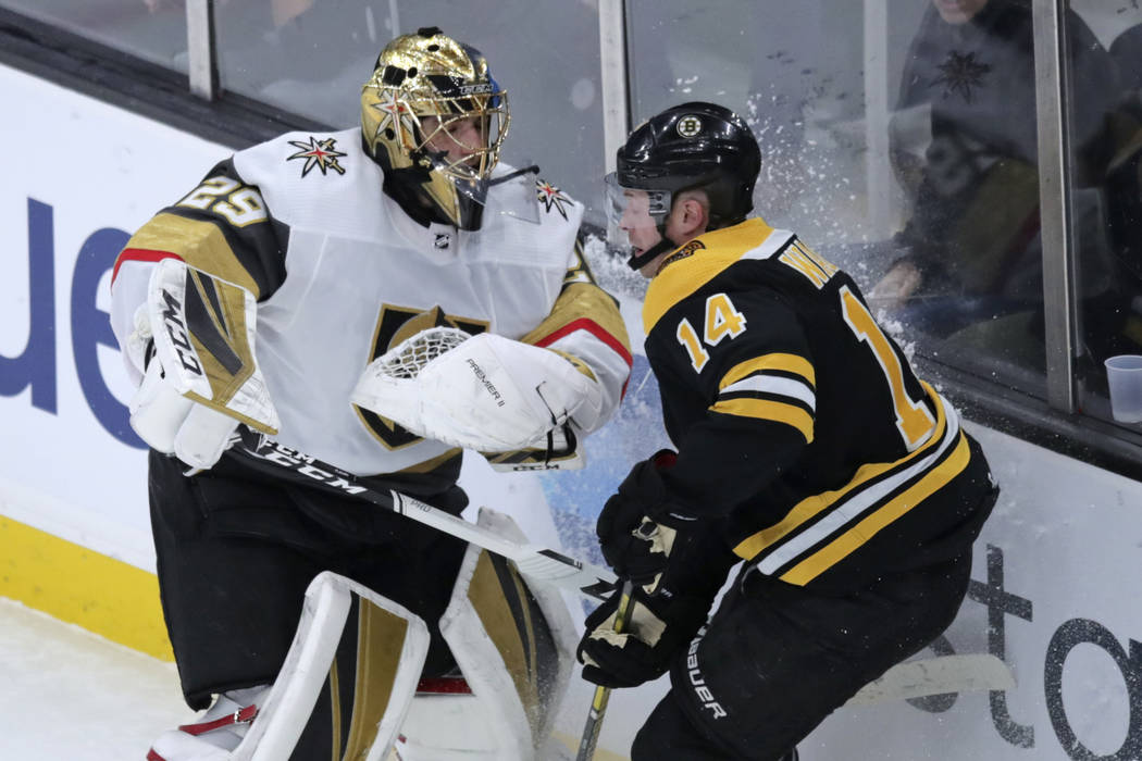 Boston Bruins right wing Chris Wagner (14) tangles with Vegas Golden Knights goaltender Marc-An ...