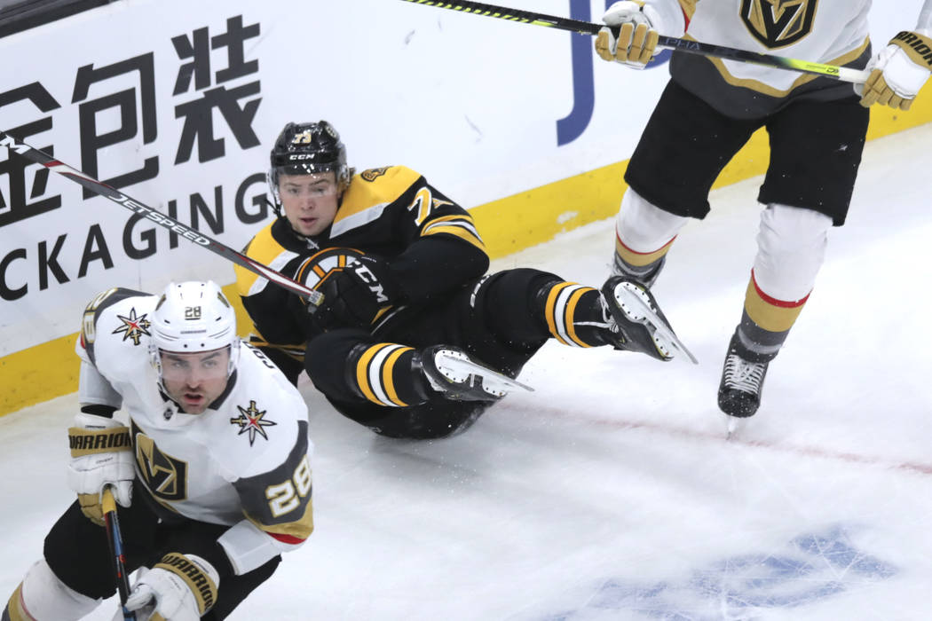 Boston Bruins defenseman Charlie McAvoy (73) hits the ice during the first period of an NHL hoc ...