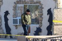 A Las Vegas police officer investigates after a person died in a shed fire at 2350 Lincoln Road ...