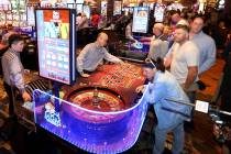 Guests play table games and machines during the opening of the MGM Springfield $960 million pro ...