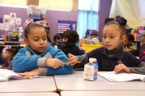 E'liana Trujillo borrows a pencil from Maryah Villezcas in Shamika Abbott's first grade class a ...
