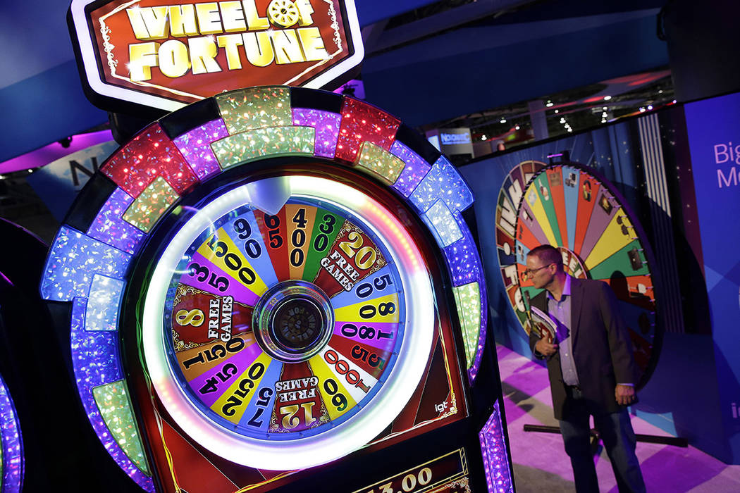 A Wheel of Fortune slot machine is seen at the IGT booth during the Global Gaming Expo, Wednesd ...