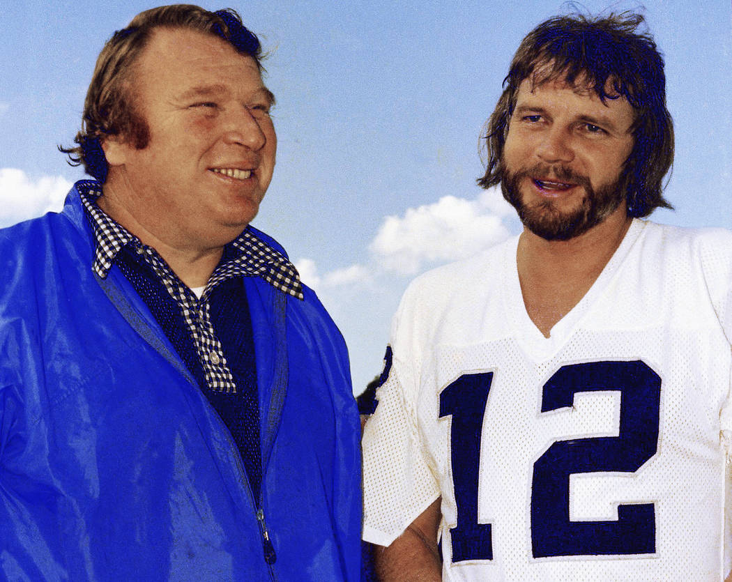 In this Jan. 4, 1977, file photo, Oakland Raiders quarterback Ken Stabler, right, talks with co ...