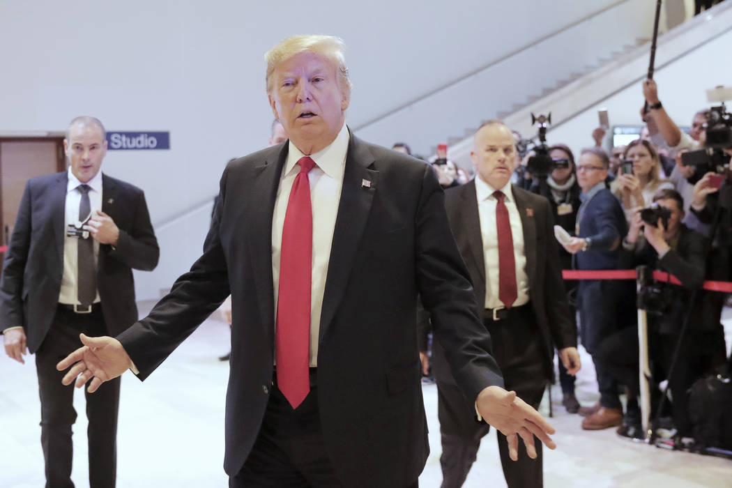 U.S. President Donald Trump leaves the World Economic Forum in Davos, Switzerland, Wednesday, J ...