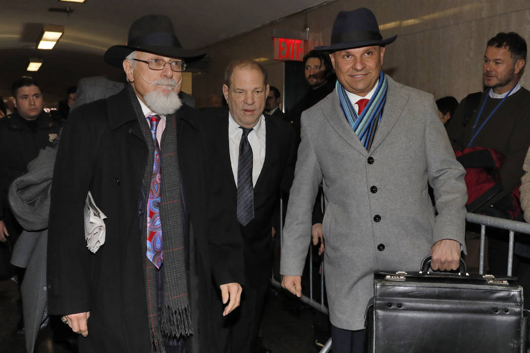 Harvey Weinstein, center, accompanied by attorney Arthur Aidala, right, arrives at court for hi ...
