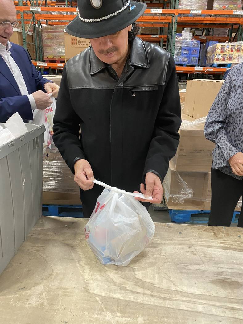 Guitar legend Carlos Santana performs some volunteer work at Three Square food bank in North La ...