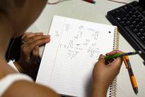 A student works on an equation in the Math Bridge class at UNLV in Las Vegas, Thursday, July 18 ...