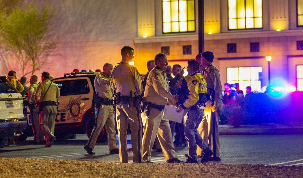 Metropolitan Police Department officers gather a Fashion Show Mall entrance near Macy's while i ...