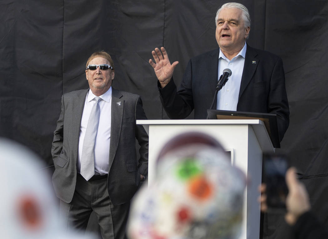 Nevada Gov. Steve Sisolak, right, and Raiders owner Mark Davis share the stage during a specia ...