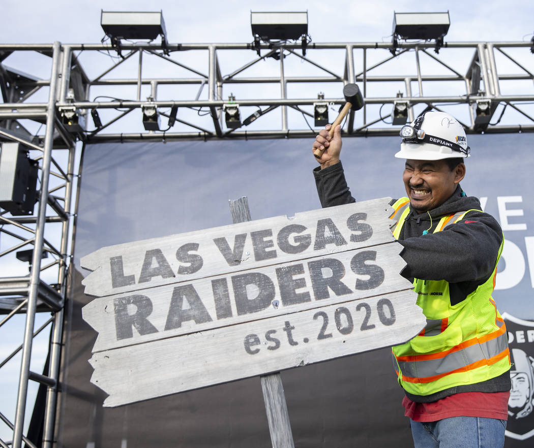 Apollo Corley drives a stake in the ceremonial Raiders sign during a special announcement at th ...