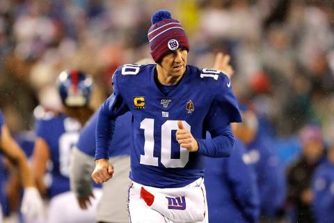 New York Giants quarterback Eli Manning (10) runs on the sideline in the second half of an NFL ...