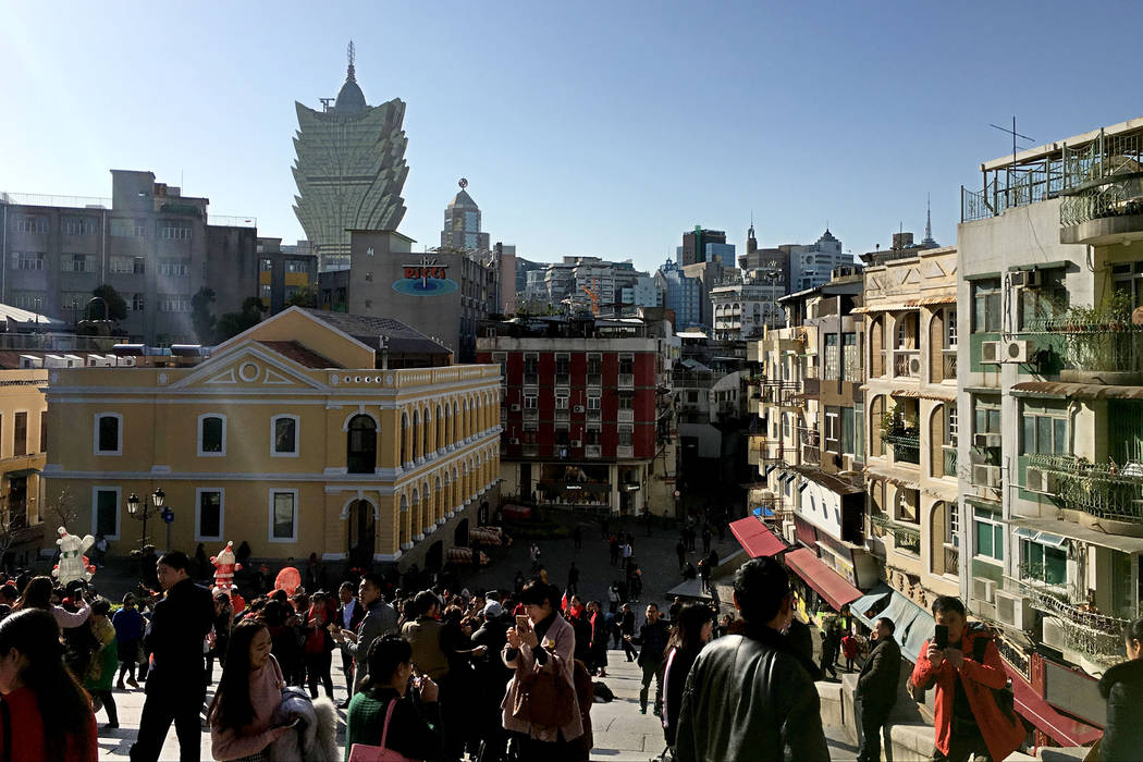 This Jan. 11, 2018, file photo shows tourists walk around the Historic Center of Macau. (Chitos ...