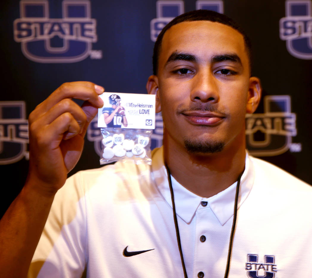 Utah State quarterback Jordan Love holds promotional candy during Mountain West football media ...