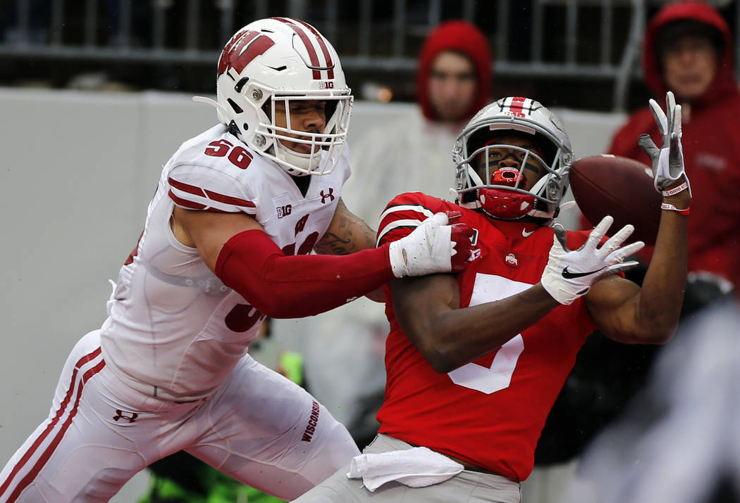 Wisconsin linebacker Zack Baun, left, interferes with Ohio State receiver Garrett Wilson during ...