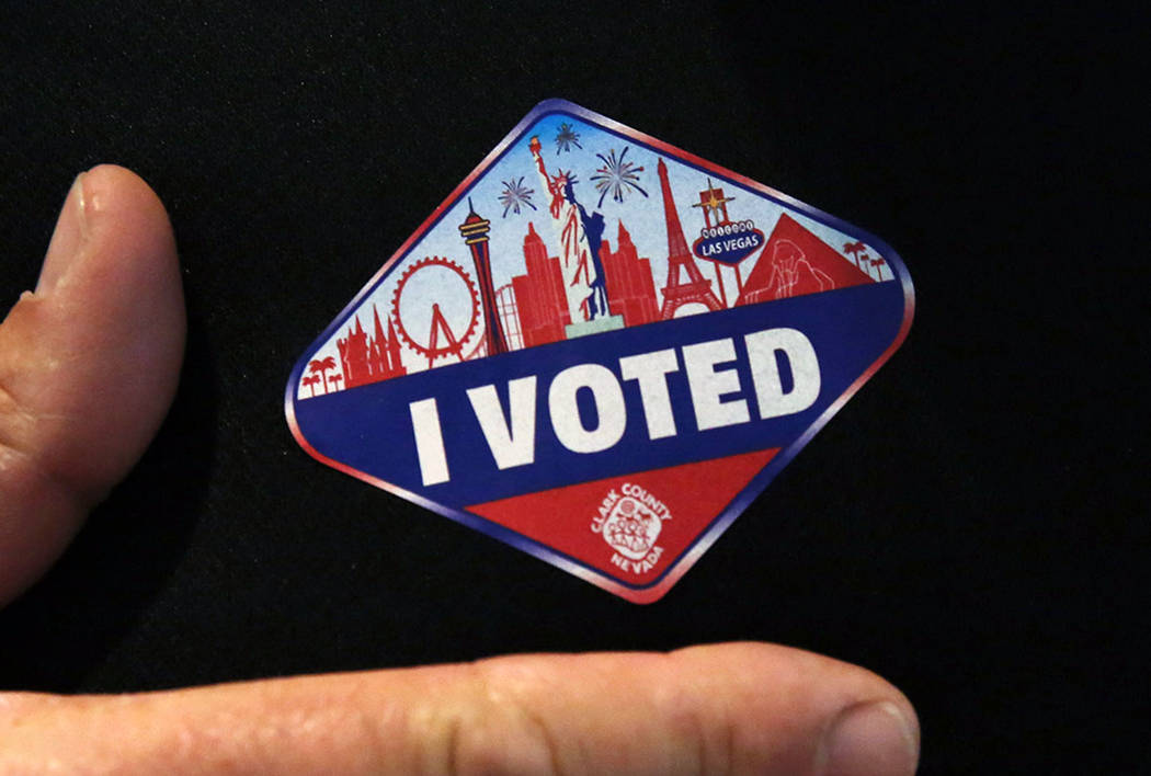 A man shows off his "I Voted" sticker after casting his ballots at a polling station at Galleri ...