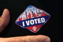 A man shows off his "I Voted" sticker after casting his ballots at a polling station at Galleri ...