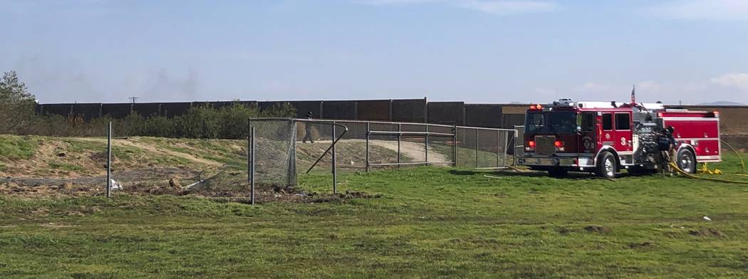 A damaged fence can be seen at left where an airplane crashed and burned at Corona Municipal Ai ...