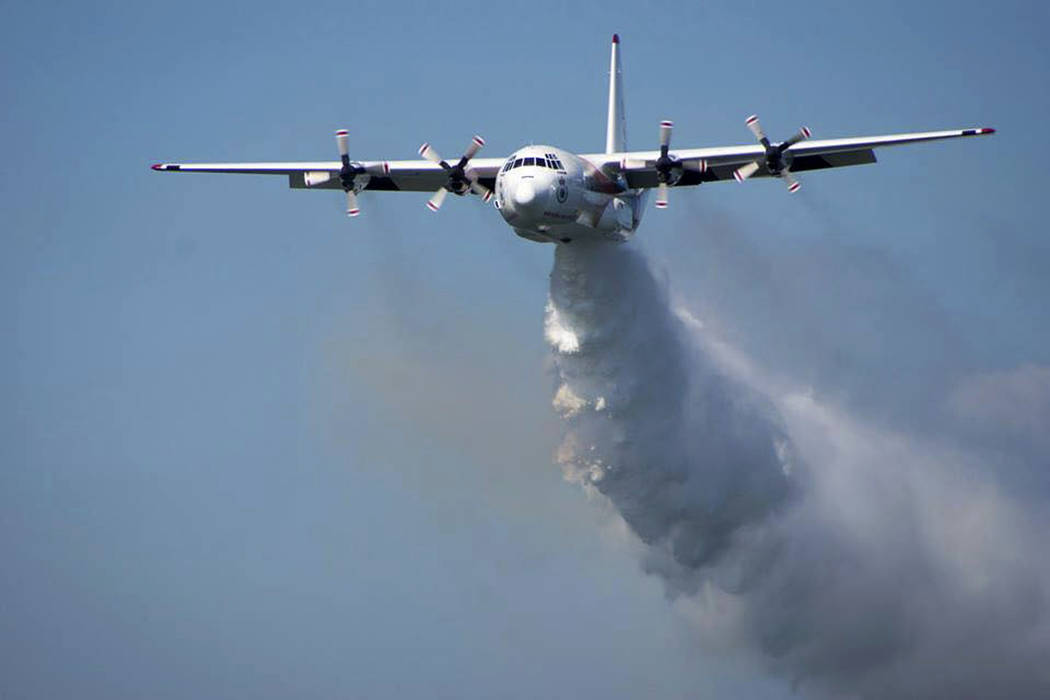 A C-130 Hercules plane called "Thor" drops water during a flight in Australia. (RFS via AP)