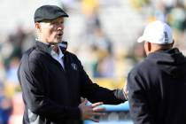 Oakland Raiders general manager Mike Mayock speaks with special team coach Rich Bisaccia before ...