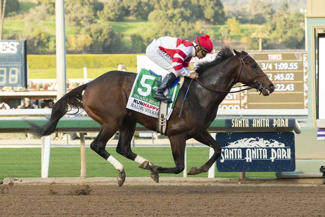 In a photo provided by Benoit Photo, Omaha Beach and jockey Mike Smith win the Grade I, $300,00 ...