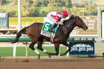 In a photo provided by Benoit Photo, Omaha Beach and jockey Mike Smith win the Grade I, $300,00 ...