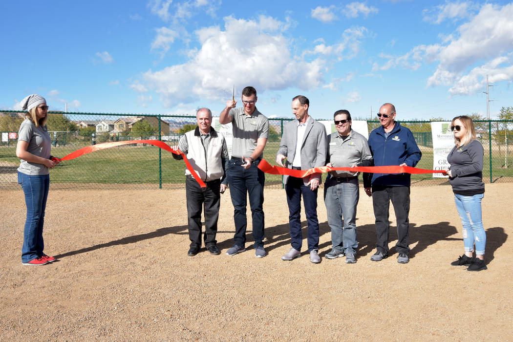Clark County Commissioner Justin Jones (center) participates in the ribbon-cutting ceremony wit ...