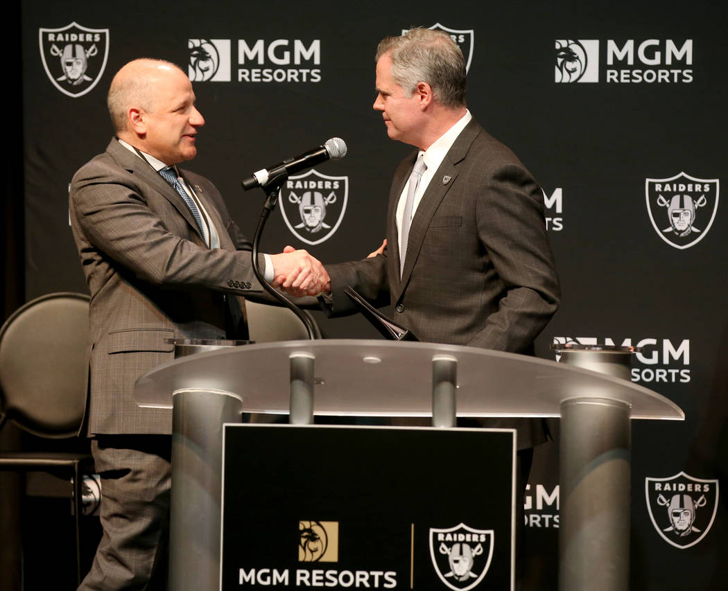 Raiders president Marc Badain, left, and Jim Murren, MGM Resorts CEO and chairman, announce a p ...