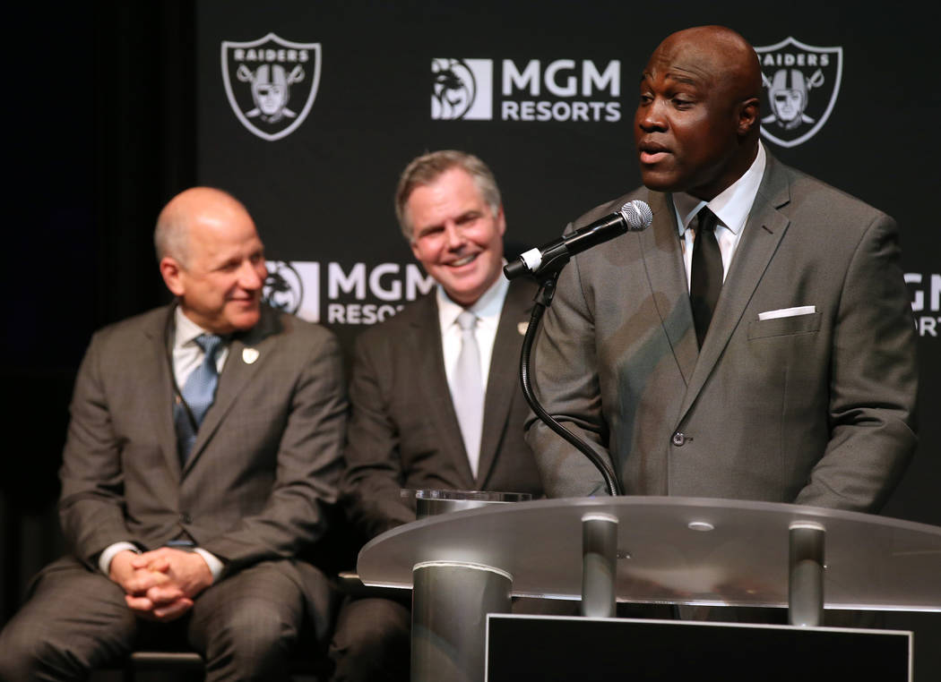 Raiders President Marc Badain, left, and Jim Murren, MGM Resorts CEO and chairman, look on as T ...