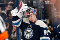 Columbus Blue Jackets' Elvis Merzlikins, of Latvia, puts his facemask on after a time out in th ...