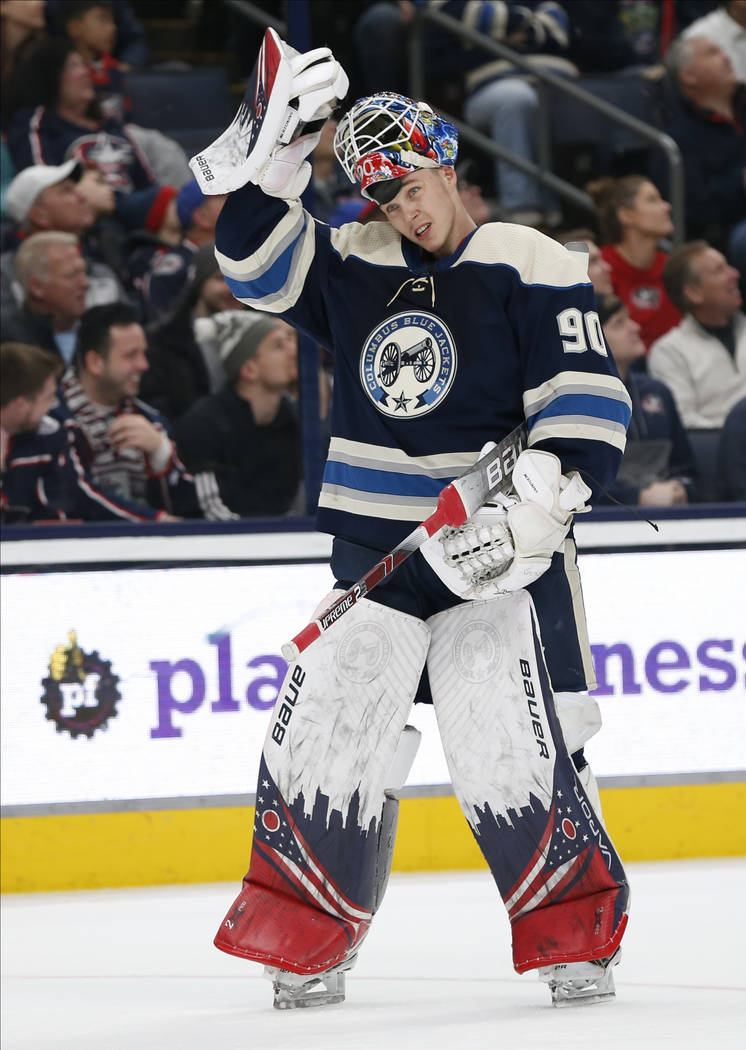 Columbus Blue Jackets' Elvis Merzlikins, of Latvia, skates back on to the ice after a time put ...