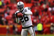 Oakland Raiders cornerback Nevin Lawson (26) catches the football during pregame drills before ...