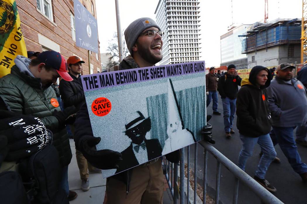 Demonstrators stand outside a security zone before a pro gun rally, Monday, Jan. 20, 2020, in R ...