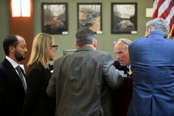 Chief Deputy District Attorneys Christopher Hamner, left, Michelle Fleck, second from left, def ...